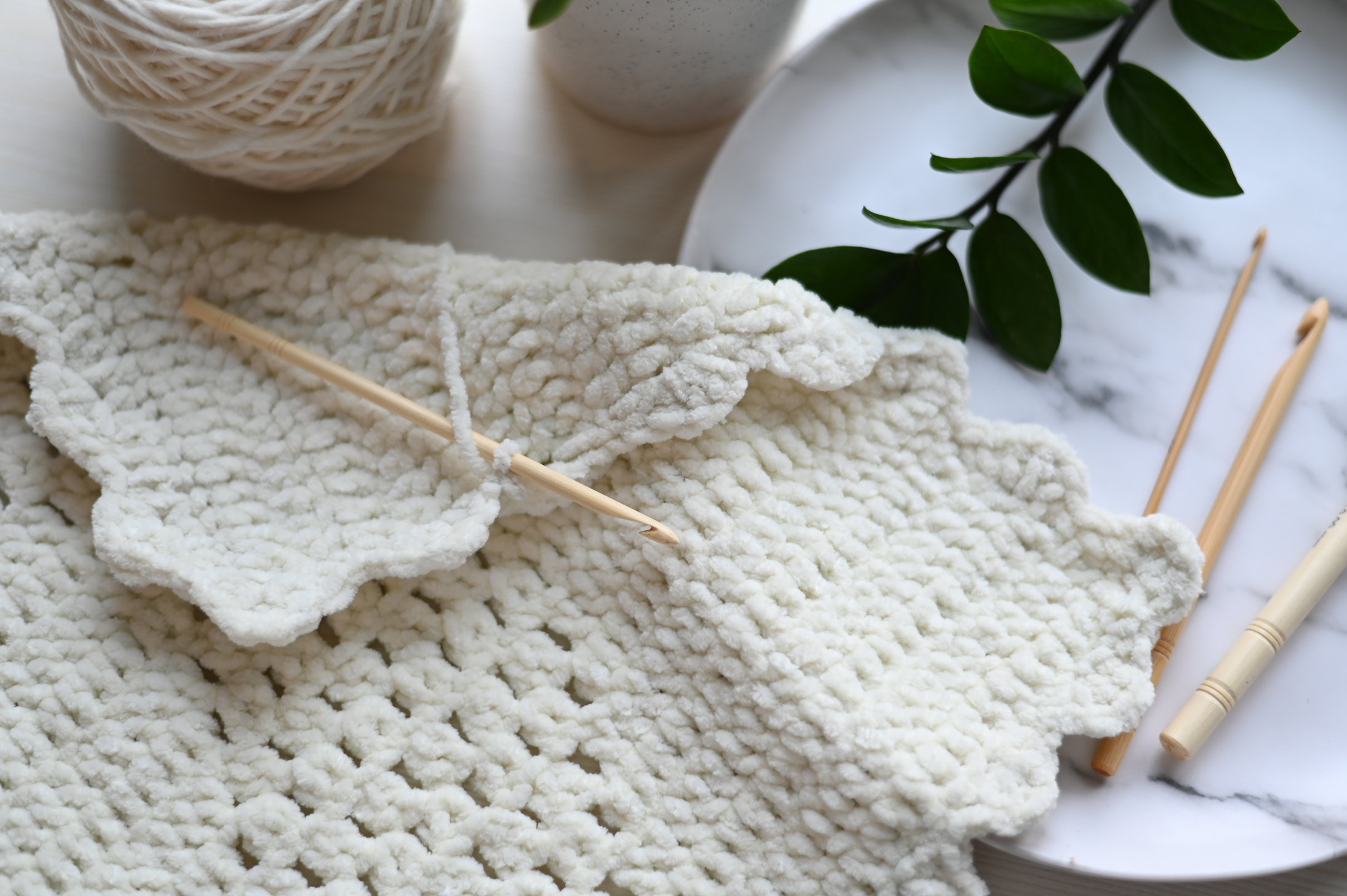 White Knit Textile With Brown Wooden Stick